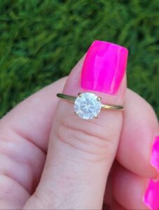 This is a beautiful 1 1/4 carat diamond solitaire ring set into a 4 prong setting. The diamond was weighed before it was set. The diamond is approx I1/I2 enhanced clarity and is E in color (colorless).This is a large diamond for a great price....but it is not perfect since it does have a slight haze to it. Diamond is bright white with no inclusions visible to naked eye.